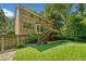 Brick house backyard featuring a deck and well manicured lawn at 786 Mitsy Pt, Marietta, GA 30068