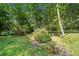 A serene backyard with a small stream and lush trees at 786 Mitsy Pt, Marietta, GA 30068