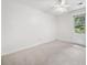 Bright bedroom with neutral carpet, ceiling fan, and natural light from the window at 786 Mitsy Pt, Marietta, GA 30068