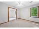 Bedroom with neutral carpet, a ceiling fan, and an adjacent room, offering versatile living space at 786 Mitsy Pt, Marietta, GA 30068