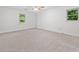 Bright, carpeted bedroom with two windows offering pleasant views and a ceiling fan for added comfort at 786 Mitsy Pt, Marietta, GA 30068