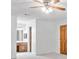 Carpeted bedroom with ceiling fan, closet door, and view into ensuite bathroom, showcasing layout and potential at 786 Mitsy Pt, Marietta, GA 30068