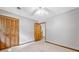 Bedroom with wood-look closet doors offers a cozy retreat with neutral tones and carpet flooring at 786 Mitsy Pt, Marietta, GA 30068