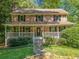 Charming two-story brick home with a welcoming front porch and lush landscaping at 786 Mitsy Pt, Marietta, GA 30068