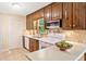 Well-lit kitchen with appliances, countertop and wood cabinets at 786 Mitsy Pt, Marietta, GA 30068