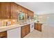 Spacious kitchen with light tile flooring, wood cabinets, and an adjacent breakfast nook area at 786 Mitsy Pt, Marietta, GA 30068