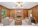 Living room featuring a brick fireplace, wood paneling, and a ceiling fan for added comfort at 786 Mitsy Pt, Marietta, GA 30068