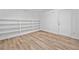 Room with new wood flooring, built in shelves and a white door at 786 Mitsy Pt, Marietta, GA 30068