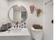 Bathroom with a modern vanity, a round mirror, and decorative wall accents at 9025 Huntwood Ln, Riverdale, GA 30274