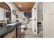 Remodeled bathroom featuring modern vanity, decorative mirror, stylish shower curtain, and wood ceiling at 9025 Huntwood Ln, Riverdale, GA 30274