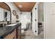 Remodeled bathroom featuring modern vanity, decorative mirror, stylish shower curtain, and wood ceiling at 9025 Huntwood Ln, Riverdale, GA 30274