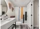 Modern bathroom featuring a stylish vanity, toilet, and tiled shower area at 9025 Huntwood Ln, Riverdale, GA 30274