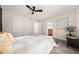 Bright bedroom featuring a ceiling fan, gray carpet, and access to the ensuite bathroom at 9025 Huntwood Ln, Riverdale, GA 30274