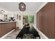 Dining room featuring modern light fixture, long table and seating, and backyard views at 9025 Huntwood Ln, Riverdale, GA 30274