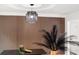 Dining area showcasing a decorative light fixture and feature wall with modern decor at 9025 Huntwood Ln, Riverdale, GA 30274
