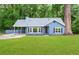 Charming, newly renovated, single-story home with an inviting exterior in a serene, wooded setting at 9025 Huntwood Ln, Riverdale, GA 30274