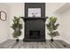 Close-up of a modern, striking fireplace flanked by stylish plants, creating a cozy and inviting ambiance at 9025 Huntwood Ln, Riverdale, GA 30274