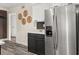 Stainless steel refrigerator and black cabinets with white quartz countertops in remodeled kitchen at 9025 Huntwood Ln, Riverdale, GA 30274