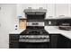 Stainless steel gas range stove with black subway tile backsplash and white quartz countertops in remodeled kitchen at 9025 Huntwood Ln, Riverdale, GA 30274