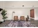Living room showcasing modern decor with chairs, a stylish rug, and a glimpse into a dining area at 9025 Huntwood Ln, Riverdale, GA 30274