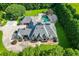 Aerial view of a large home and in-ground pool surrounded by lush green landscaping and mature trees at 2871 Hosch Valley Rd, Buford, GA 30519
