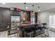 Chic bar area with modern stools, stainless steel refrigerator, and custom cabinetry at 2871 Hosch Valley Rd, Buford, GA 30519