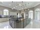 Modern kitchen with a large center island, custom cabinets, and stylish pendant lighting fixtures at 2871 Hosch Valley Rd, Buford, GA 30519