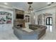 Open living space with stone fireplace, custom built-ins, large sectional, and elegant archway at 2871 Hosch Valley Rd, Buford, GA 30519