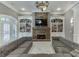 Bright living room with a stone fireplace, custom built-ins, and an oversized sectional couch at 2871 Hosch Valley Rd, Buford, GA 30519