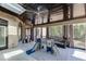 View of indoor patio with marble floors, dark wood ceiling, brick wall, furniture, and play set at 2871 Hosch Valley Rd, Buford, GA 30519