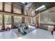 View of indoor patio with marble floors, dark wood ceiling, furniture, play set, and access to the backyard at 2871 Hosch Valley Rd, Buford, GA 30519