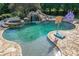 View of in-ground pool with stone patio, waterfall, hot tub, and water slide at 2871 Hosch Valley Rd, Buford, GA 30519