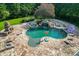 View of in-ground pool with stone patio, waterfall, hot tub, water slide, built-in grill, and basketball hoop at 2871 Hosch Valley Rd, Buford, GA 30519