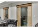 Finished sauna room with wood paneling and view of an attached living space at 2871 Hosch Valley Rd, Buford, GA 30519