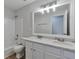 Bathroom featuring dual sinks, white cabinets, and tiled shower and tub at 3686 Claredun Ct, Cumming, GA 30040