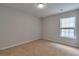 Bedroom with neutral carpet, gray walls, one window, and base molding at 3686 Claredun Ct, Cumming, GA 30040