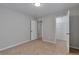 Bedroom featuring neutral carpet, gray walls, and white doors that open into closet at 3686 Claredun Ct, Cumming, GA 30040