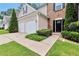 Charming home exterior featuring a well-maintained lawn and a two-car garage at 3686 Claredun Ct, Cumming, GA 30040