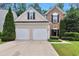 Charming home with a two-car garage, well-manicured lawn, and mature trees at 3686 Claredun Ct, Cumming, GA 30040