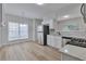 Eat-in kitchen with stainless steel appliances, white cabinets, and bright natural light at 3686 Claredun Ct, Cumming, GA 30040