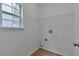 Laundry room features wood floors, a window for natural light, and washer/dryer hookups at 3686 Claredun Ct, Cumming, GA 30040