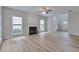 Spacious living room featuring wood floors and a cozy fireplace at 3686 Claredun Ct, Cumming, GA 30040