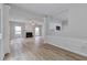 Spacious living room with wood floors, a fireplace, and an open kitchen at 3686 Claredun Ct, Cumming, GA 30040