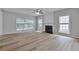 Bright and airy living room featuring wood floors and a classic fireplace at 3686 Claredun Ct, Cumming, GA 30040
