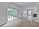 Spacious living room with a fireplace, wainscotting, and sliding glass doors to the exterior at 3686 Claredun Ct, Cumming, GA 30040