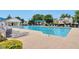 Community pool surrounded by lounge chairs, greenery, and covered seating area at 3686 Claredun Ct, Cumming, GA 30040