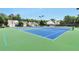 Community tennis courts on a clear day with houses in the background at 3686 Claredun Ct, Cumming, GA 30040
