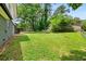 Large, well-maintained backyard with lush green grass and tree line at 5058 Rock Springs Rd, Lithonia, GA 30038