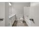 Neutral bathroom featuring white fixtures and wood-look floors at 5058 Rock Springs Rd, Lithonia, GA 30038