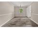 Neutral dining room with wood-look floors, a chandelier, and a view of the kitchen, perfect for gatherings at 5058 Rock Springs Rd, Lithonia, GA 30038